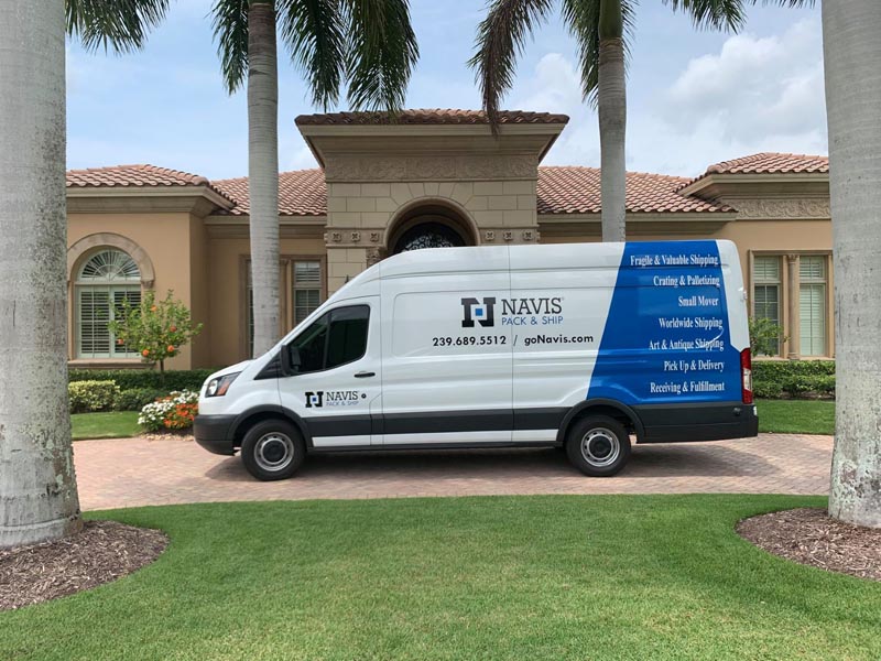 Navis van with blue and white stripes in front of a house